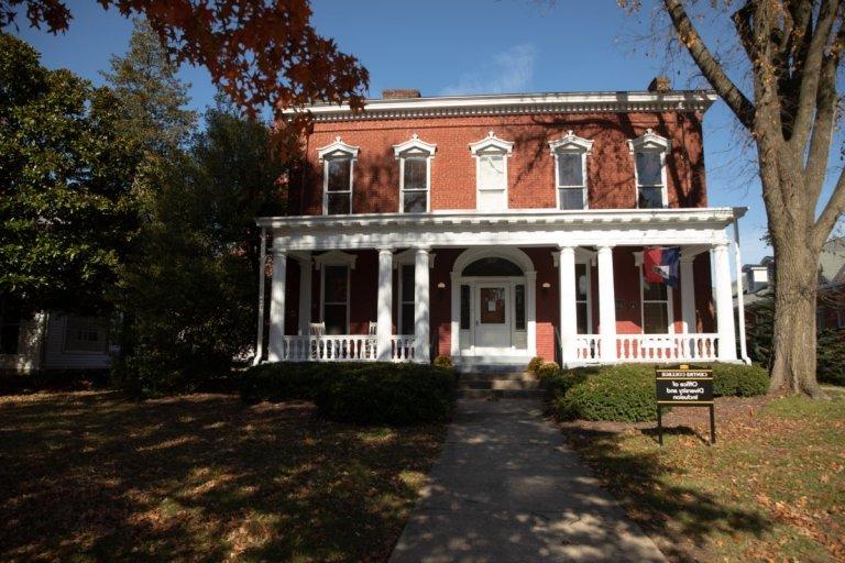 exterior of two story brick house with porch on front